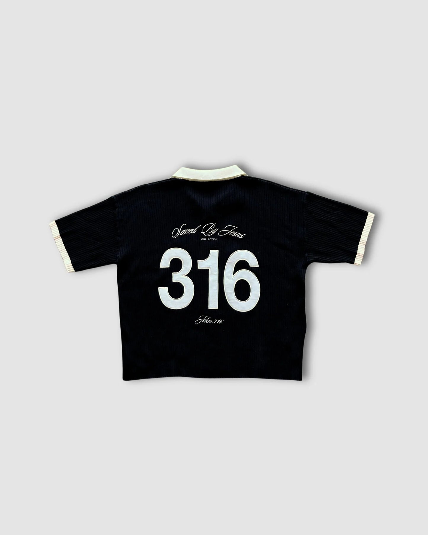 Black shirt with white text and numbers on a light gray background