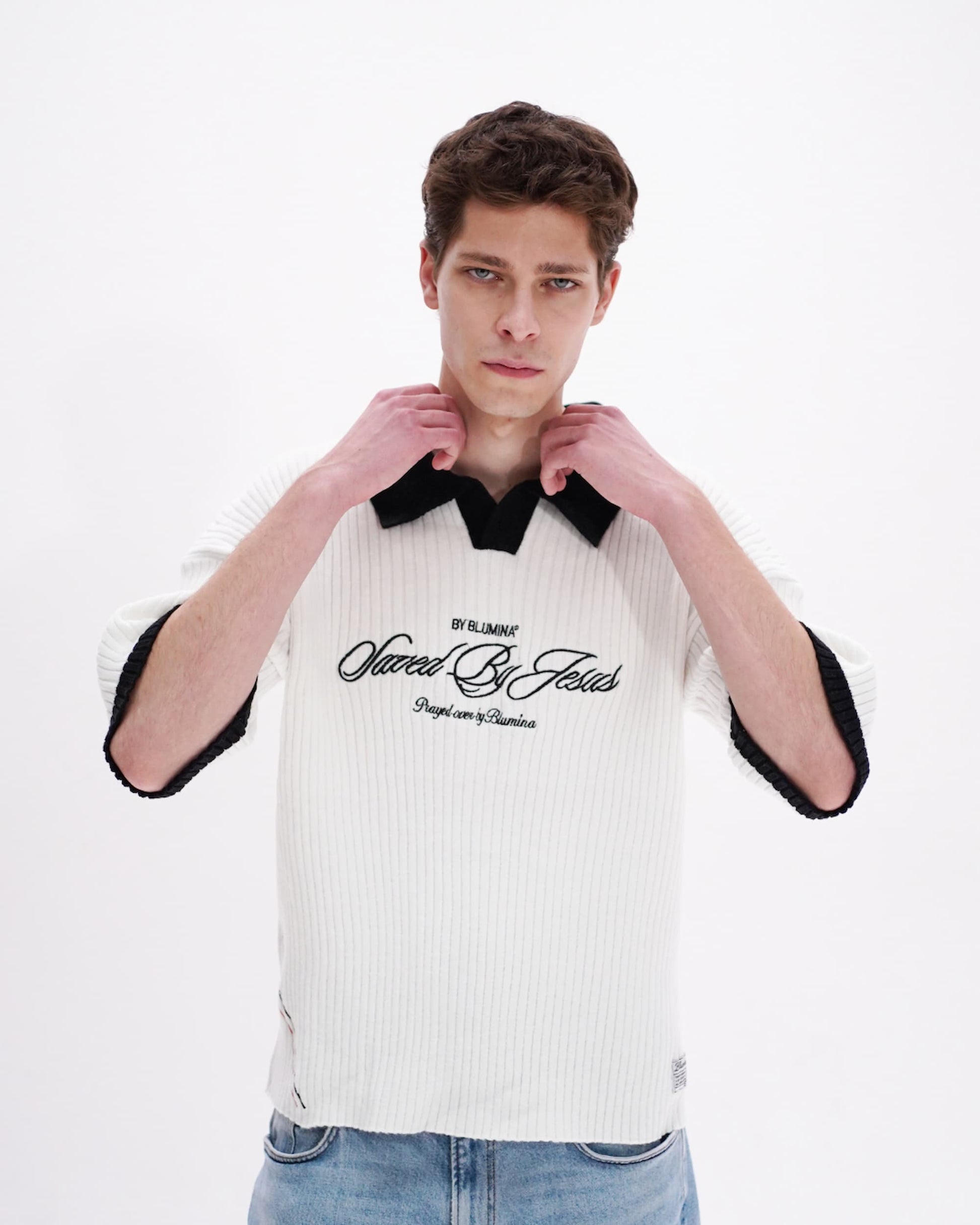 Man wearing a white and black striped shirt with text on a white background