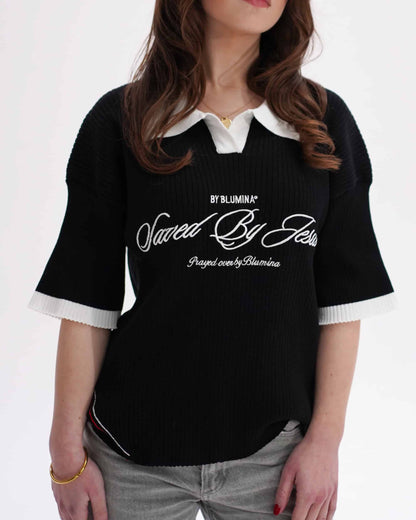 Black shirt with white collar and text worn by a person on a white background