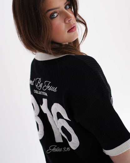 Woman wearing a black sweater with text on the back against a white background