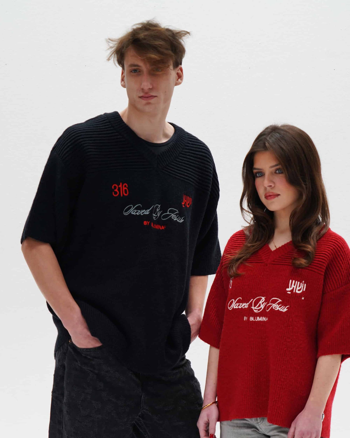 Two people wearing black and red shirts with text on a white background