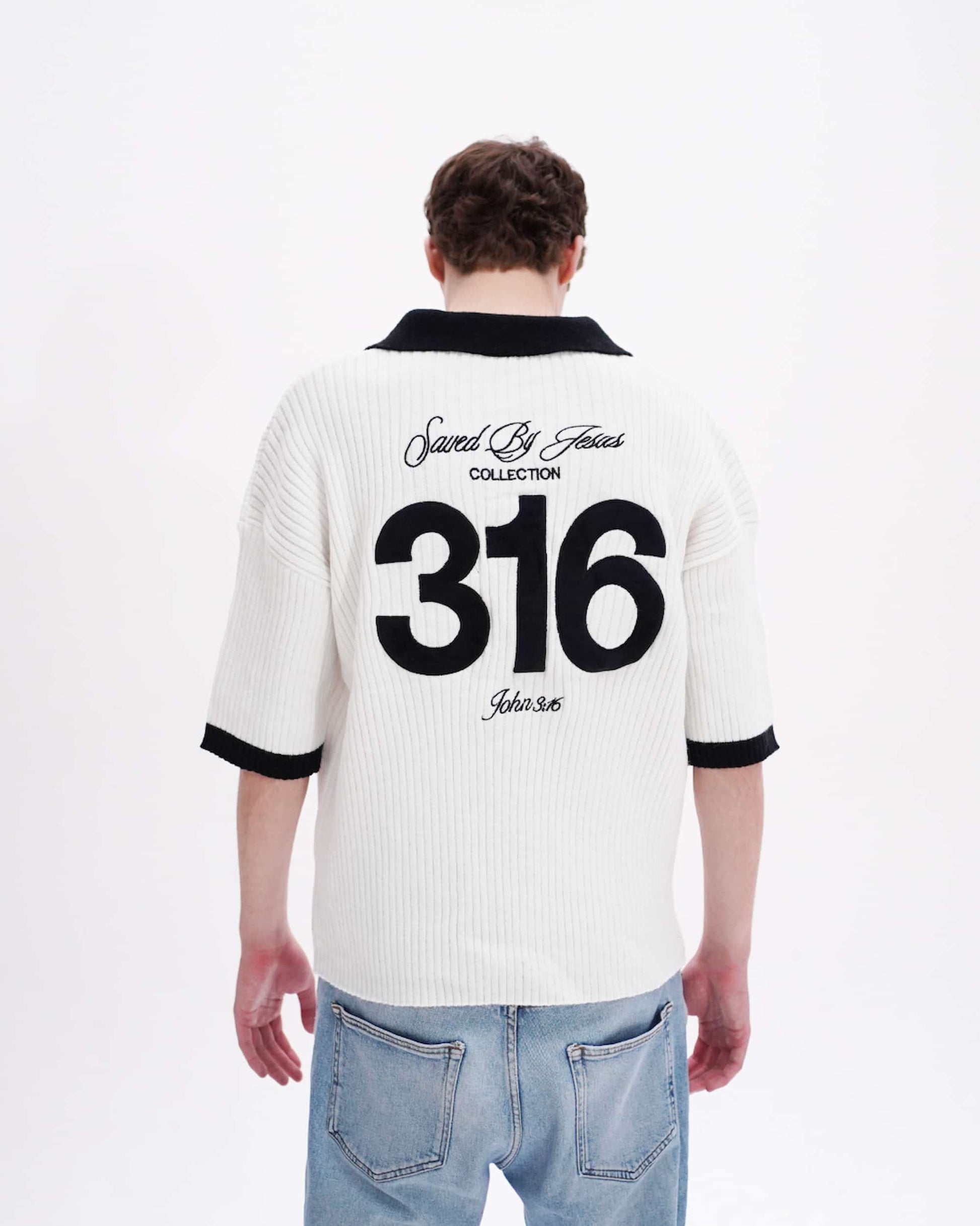 Person wearing a white polo shirt with black text and numbers on the back, standing against a white background.